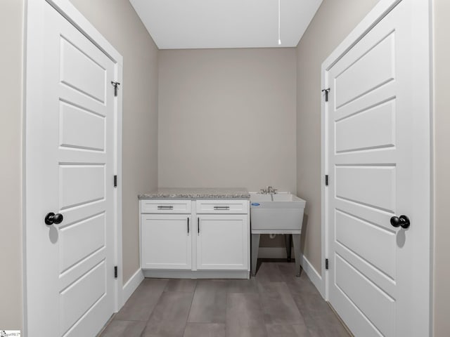 washroom with sink and light hardwood / wood-style flooring