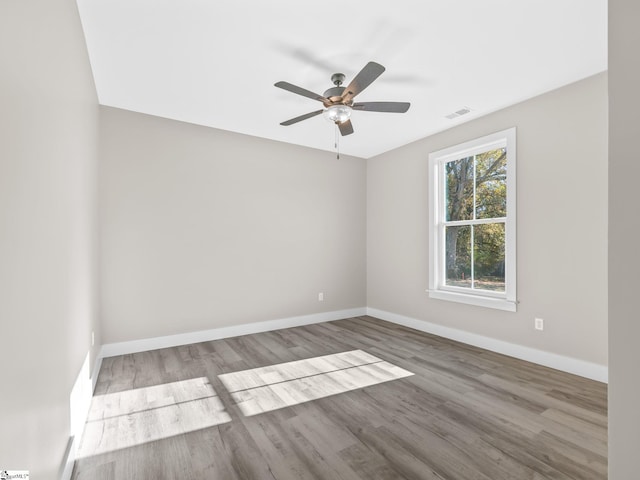 spare room with hardwood / wood-style flooring and ceiling fan