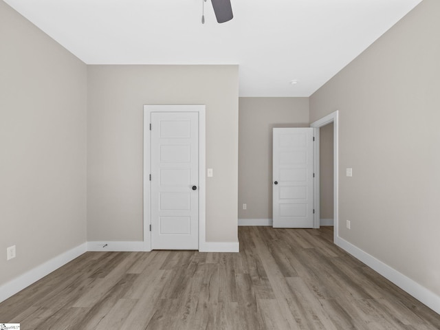 unfurnished bedroom with ceiling fan and light wood-type flooring