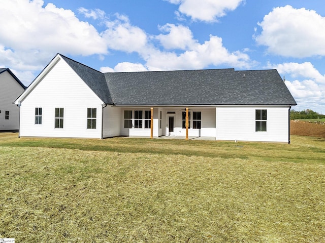 back of house with ceiling fan, a patio, and a yard