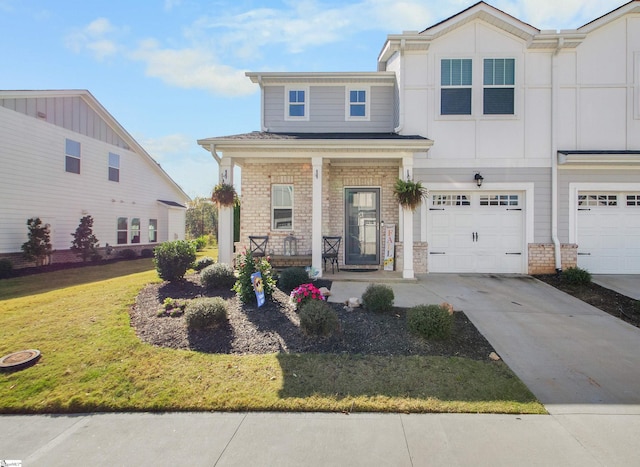 view of front of home with covered porch, a garage, and a front lawn