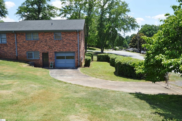 view of side of home with a garage and a yard