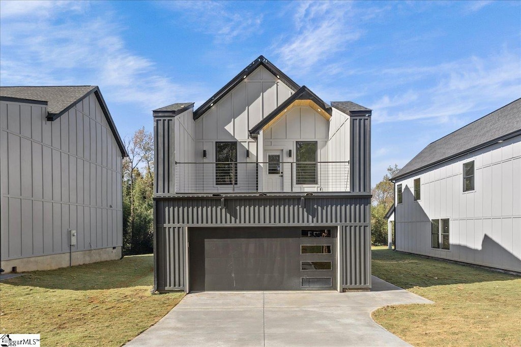 modern farmhouse style home featuring a front yard, a balcony, and a garage