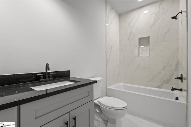 full bathroom featuring vanity, tiled shower / bath combo, and toilet