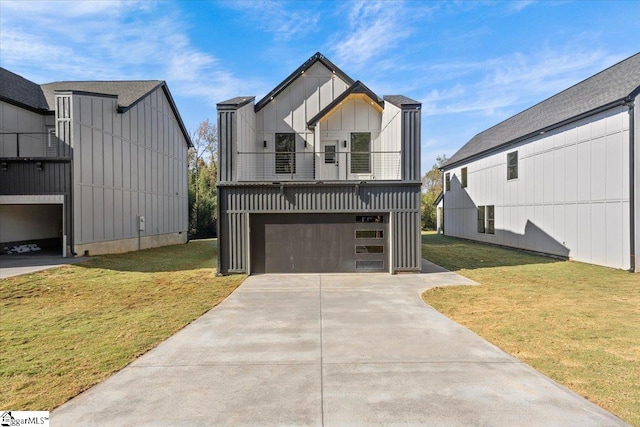 view of front of home with a balcony, a front lawn, and a garage