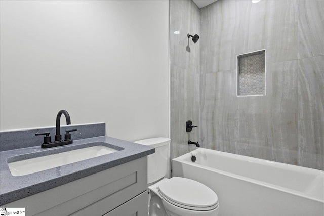 full bathroom featuring vanity, toilet, and tiled shower / bath combo