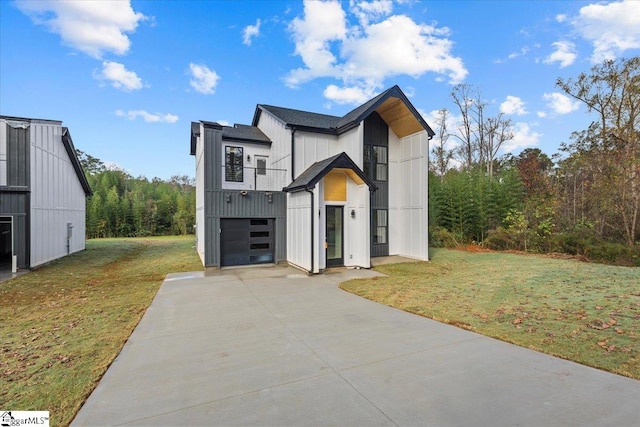 modern farmhouse featuring a front yard, a balcony, and a garage