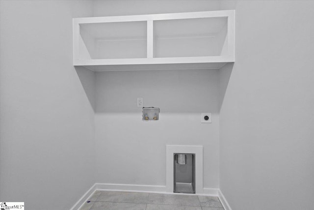 washroom with hookup for an electric dryer, hookup for a washing machine, and light tile patterned flooring
