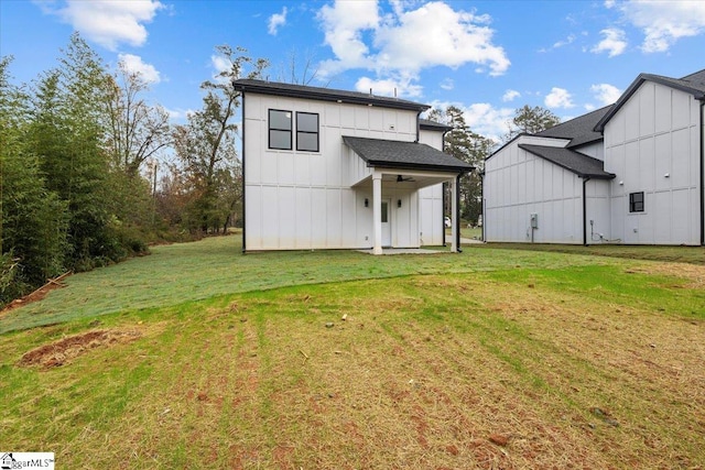 back of property featuring a lawn