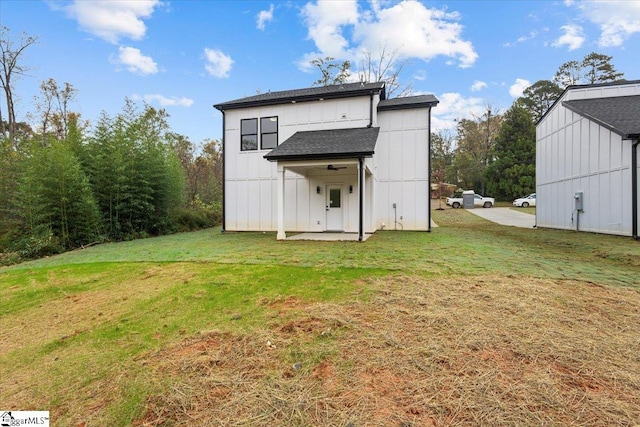 rear view of property with a lawn