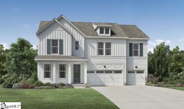 view of front of property with a garage and a front lawn