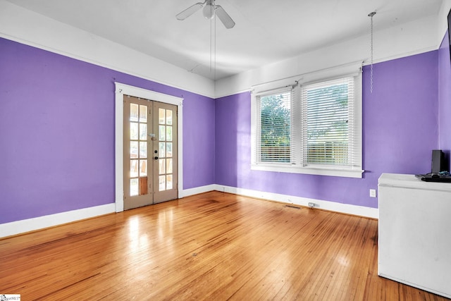 1303 E River St, Anderson, SC 29624 - unfurnished room with baseboards, french doors, hardwood / wood-style floors, and a ceiling fan