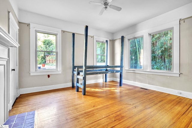 1303 E River St, Anderson, SC 29624 - bedroom featuring multiple windows, light wood-style flooring, baseboards, and a ceiling fan