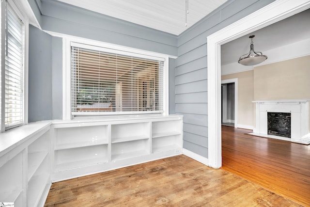 1303 E River St, Anderson, SC 29624 - unfurnished dining area featuring wood finished floors and a fireplace