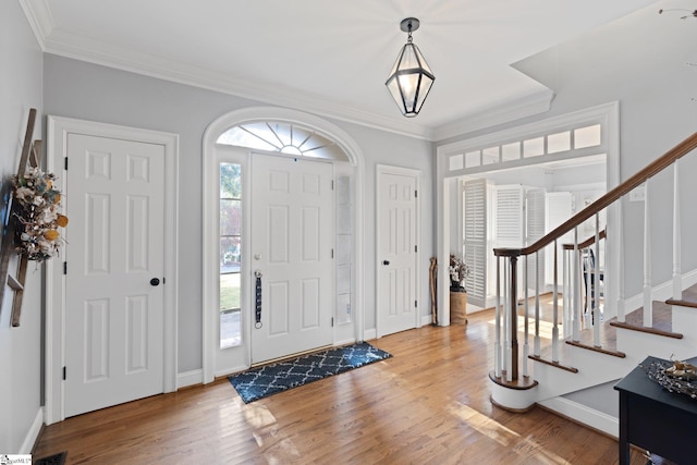 entryway with hardwood / wood-style flooring and ornamental molding