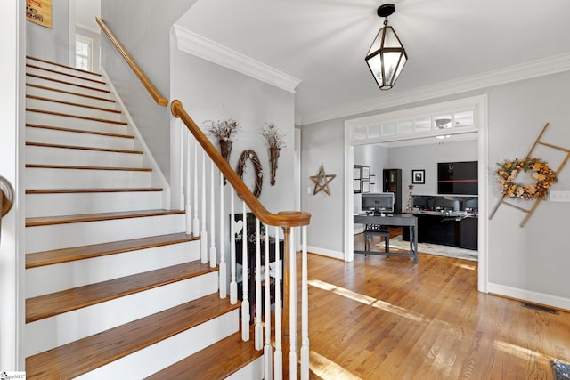 foyer featuring hardwood / wood-style flooring and ornamental molding