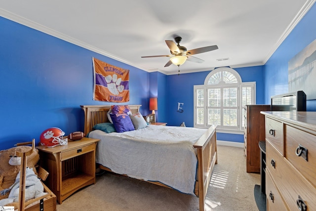 carpeted bedroom featuring ornamental molding and ceiling fan