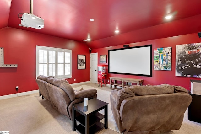 cinema featuring vaulted ceiling and light colored carpet