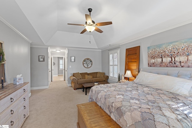 carpeted bedroom with ceiling fan, crown molding, and a tray ceiling