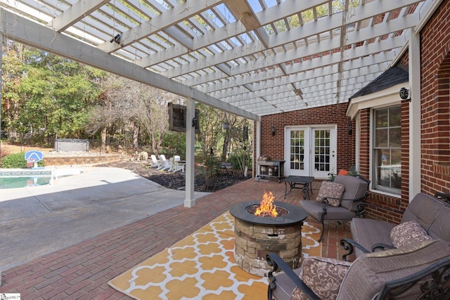 view of patio / terrace with an outdoor living space with a fire pit and a pergola