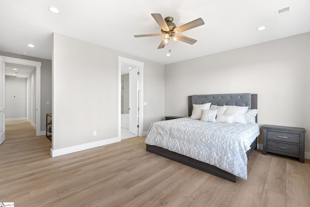 bedroom featuring ensuite bathroom, ceiling fan, and light hardwood / wood-style flooring