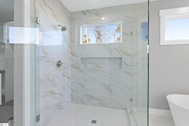 bathroom with a wealth of natural light and independent shower and bath