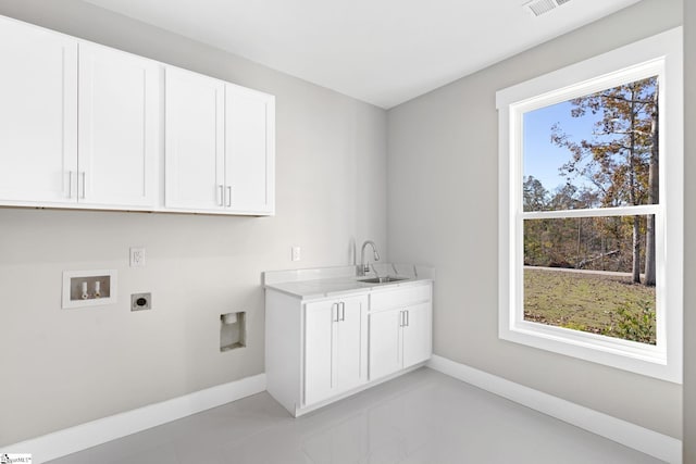 laundry room featuring washer hookup, cabinets, sink, and hookup for an electric dryer