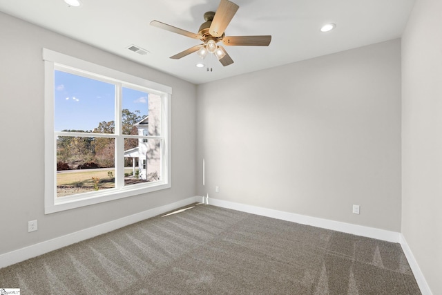 spare room featuring ceiling fan and carpet