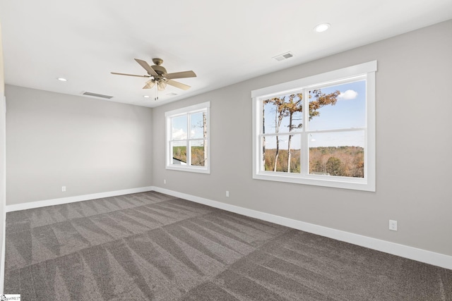 carpeted spare room with ceiling fan