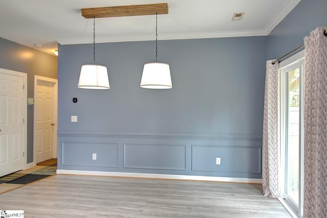 empty room featuring crown molding and light hardwood / wood-style flooring