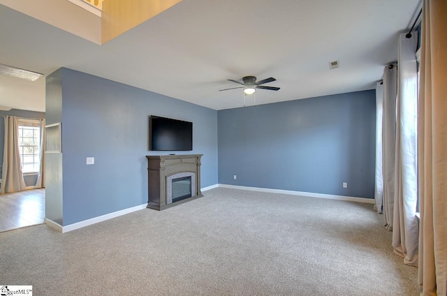 225 Worcester Ln, Easley, SC 29642 - unfurnished living room with light carpet, ceiling fan, baseboards, and a fireplace with flush hearth