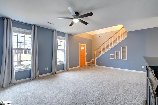 225 Worcester Ln, Easley, SC 29642 - unfurnished living room with a ceiling fan, carpet, and stairway