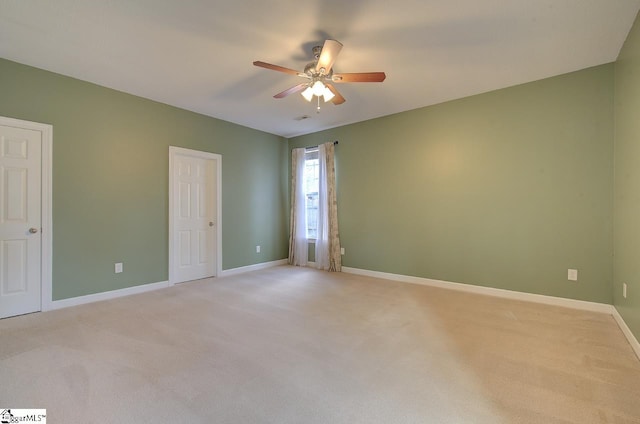 unfurnished room with light carpet and ceiling fan