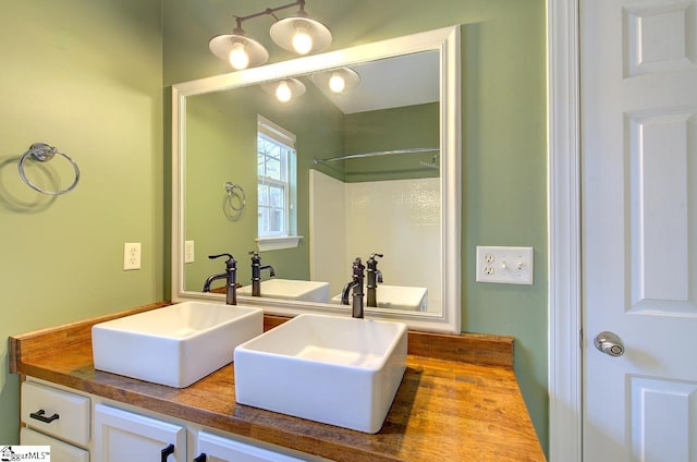 bathroom with a shower and vanity