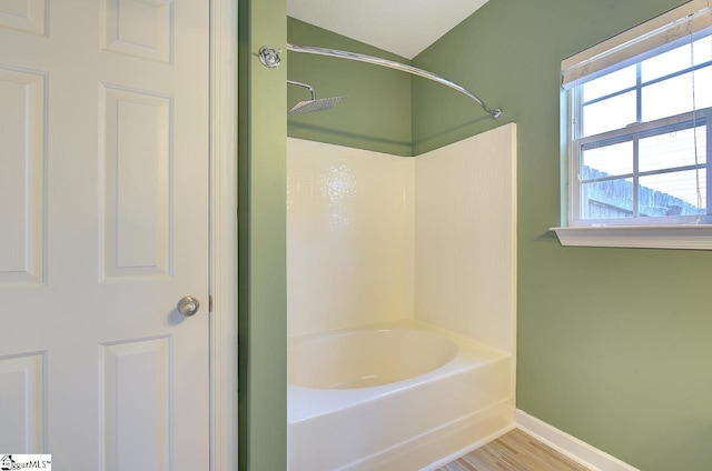 bathroom featuring tub / shower combination and hardwood / wood-style flooring