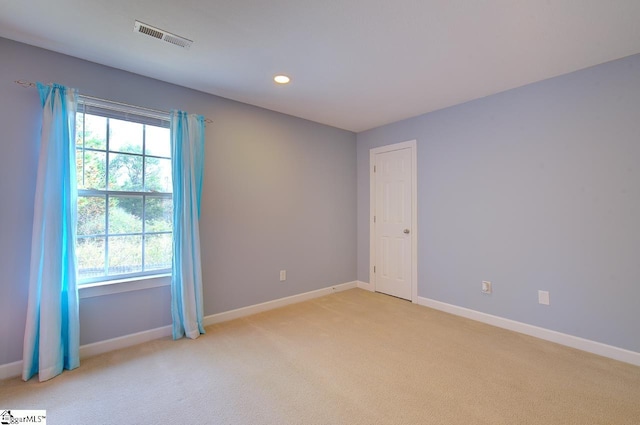 spare room with light colored carpet