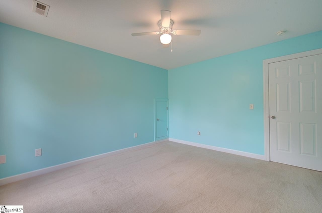 unfurnished room with light colored carpet and ceiling fan