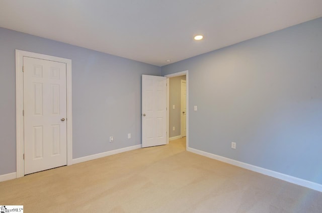 225 Worcester Ln, Easley, SC 29642 - unfurnished bedroom with light colored carpet, baseboards, and recessed lighting