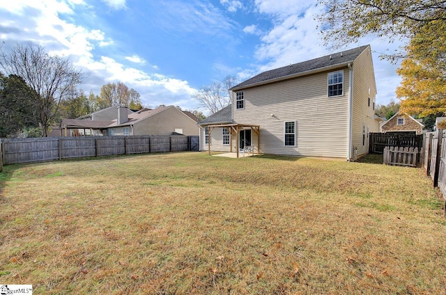 back of property with a patio and a yard