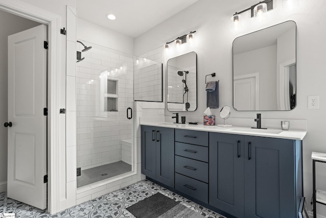 bathroom featuring vanity, tile patterned floors, and a shower with shower door