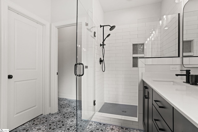 bathroom with an enclosed shower, vanity, and tile patterned floors