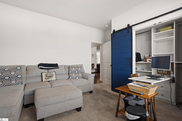 home office with a barn door and light colored carpet