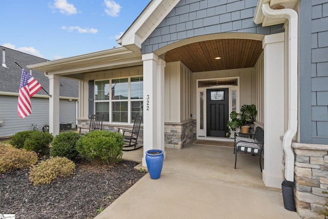 property entrance featuring central air condition unit and covered porch