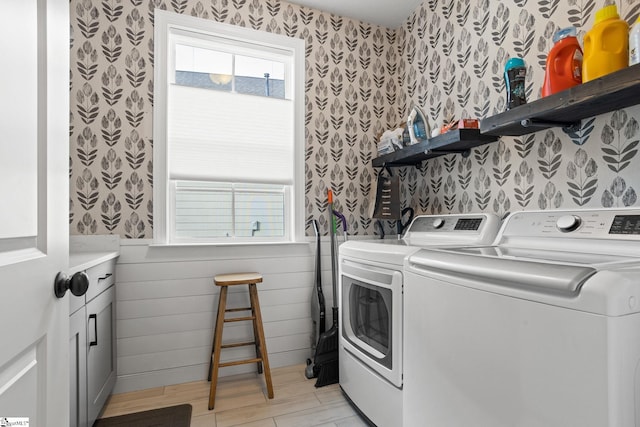 laundry area with washing machine and dryer and light hardwood / wood-style floors