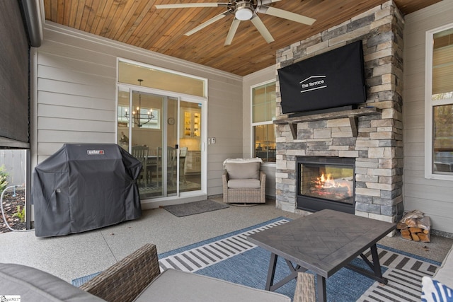 view of patio with a grill, ceiling fan, and an outdoor stone fireplace