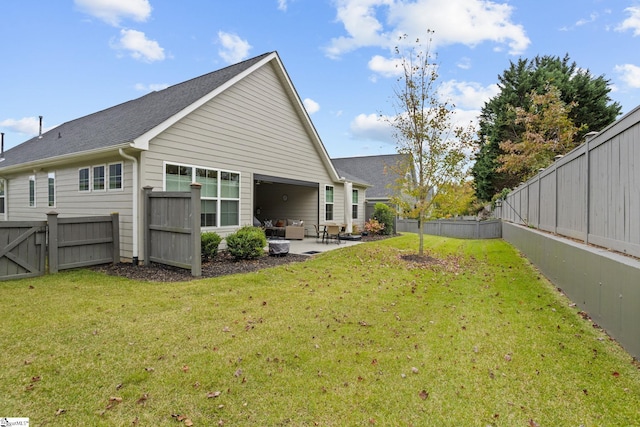 rear view of property featuring a lawn and a patio