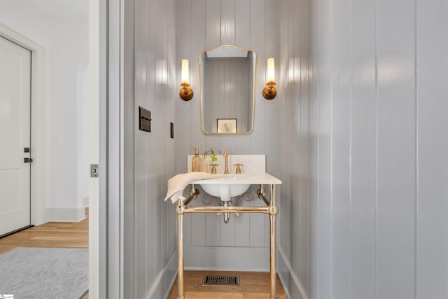 bathroom with hardwood / wood-style flooring