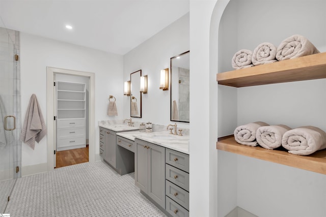 bathroom featuring hardwood / wood-style flooring, vanity, and a shower with door