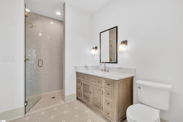 bathroom with toilet, vanity, tile patterned floors, and a shower with door