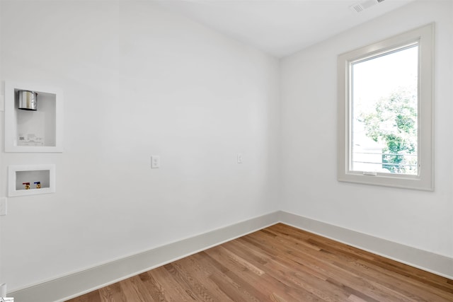 unfurnished room with light wood-type flooring and a wealth of natural light